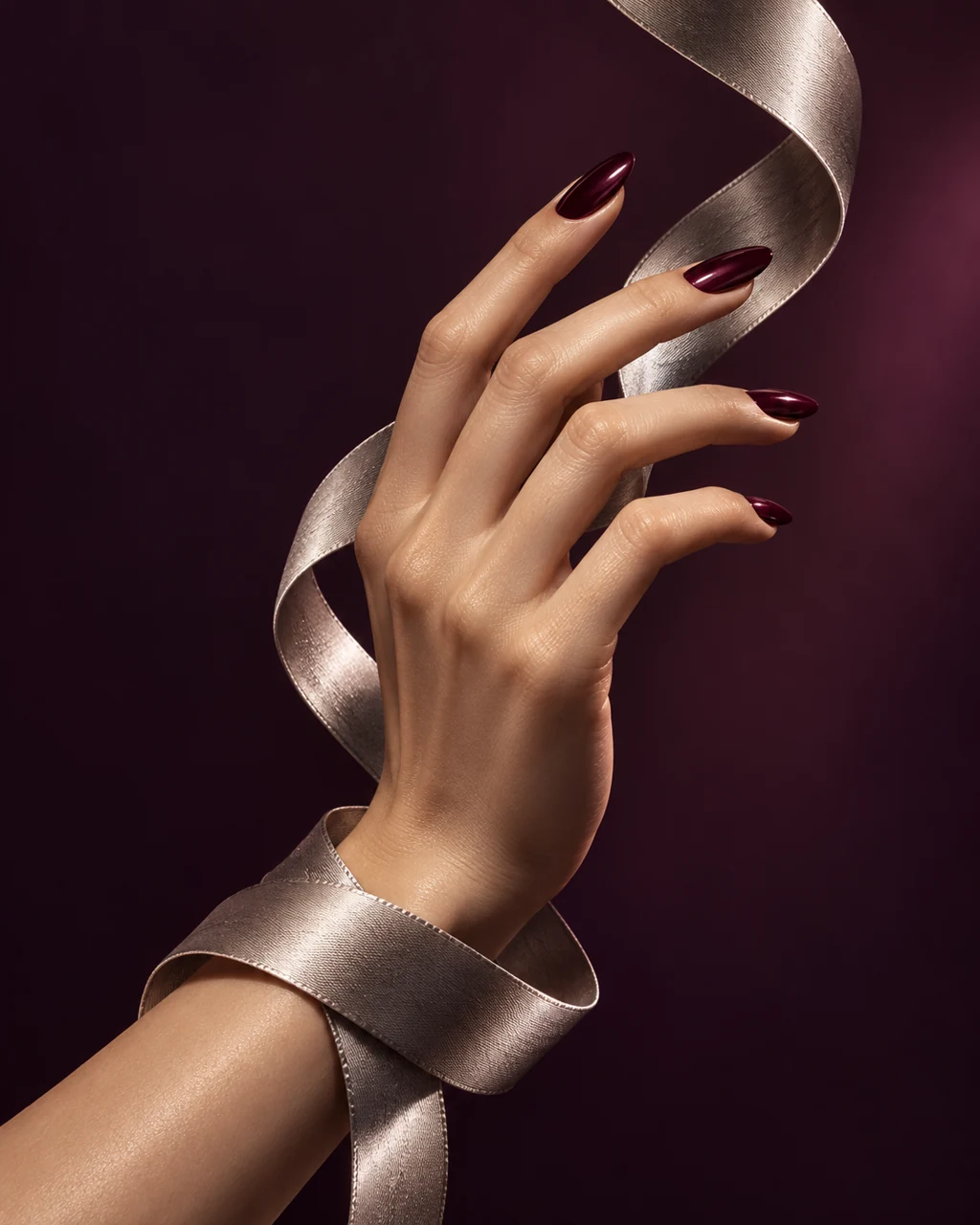 AI campaign concept: burgundy manicure with a sculptural silver ribbon